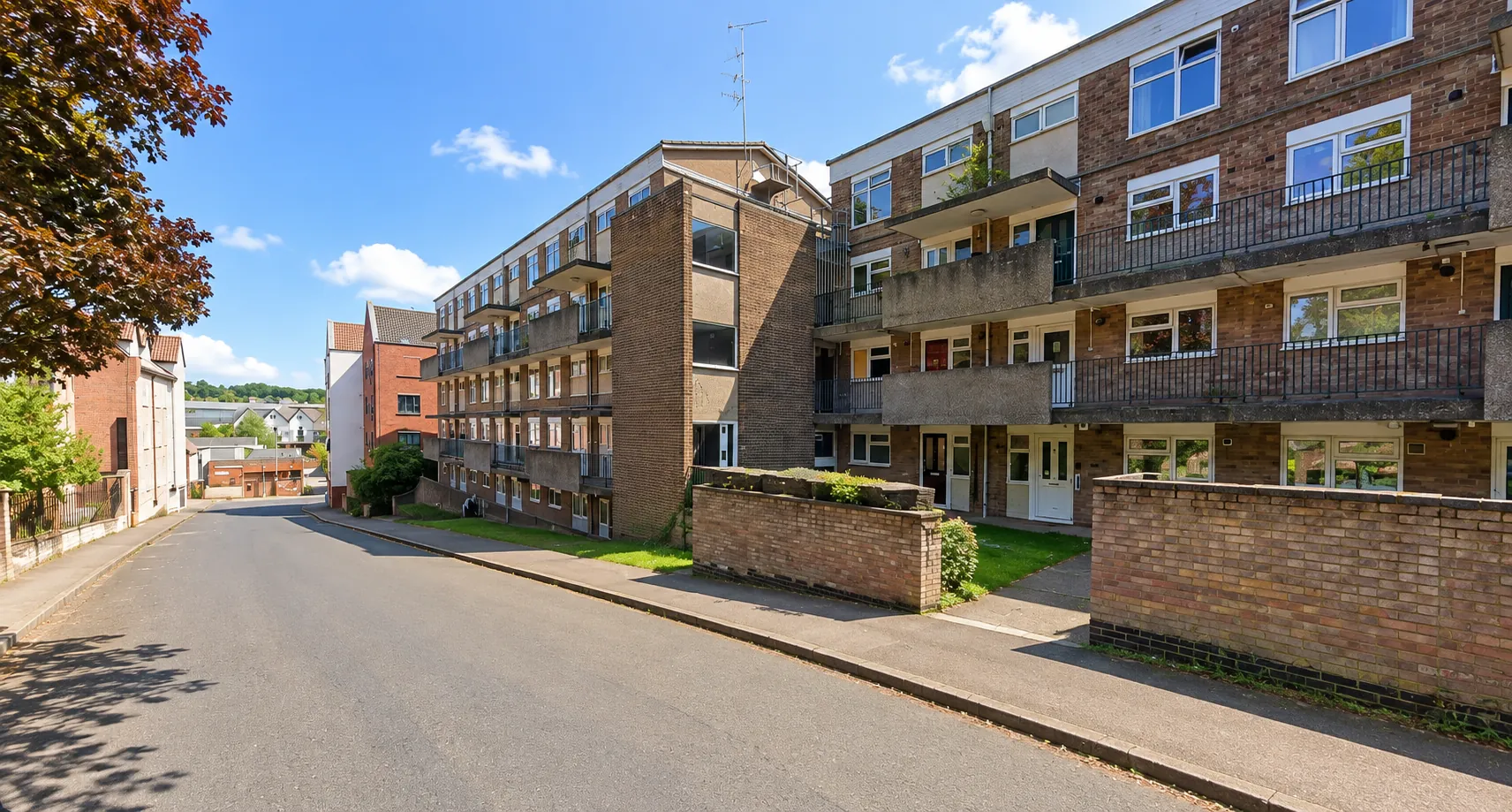 The apartment block from the street, wider view