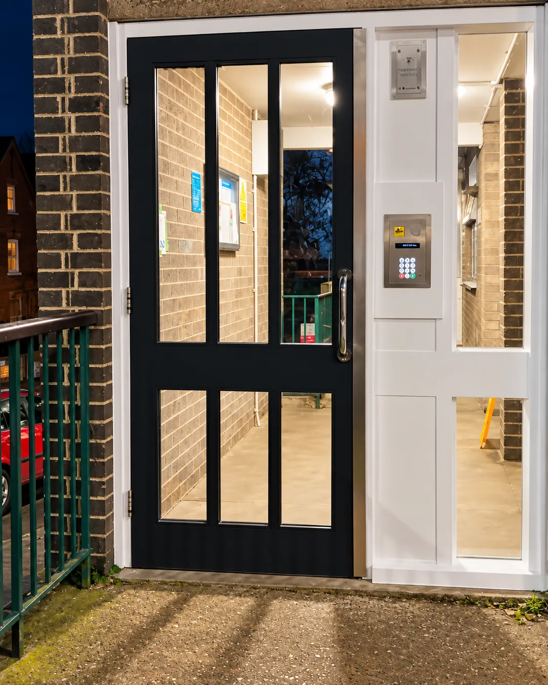 Communal entrance door at night, keypad lit up
