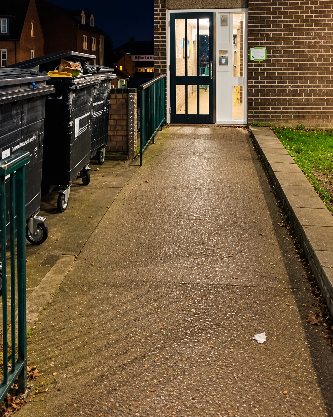 Path to the communal entrance, bins to the left